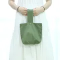 Minimalist solid color canvas wrist bag for women, casual green handbag with snap button. - Army Green