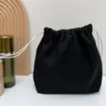 Schwarzer Kosmetikbeutel aus Leinen mit Kordelzug, einfarbige Reisetasche für Alltag. - S / Schwarz