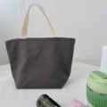 Dark grey canvas lunch bag tote with sturdy handles and zipper closure, practical for daily use. - Dark Gray