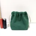 Einfarbiger Canvas Kordelzug Kosmetiktasche tragbare staubdichte Aufbewahrungstasche für Damen. - Avocadogrün