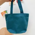 Einfarbige Canvas-Lunchtasche, tealfarbene Hand-Kosmetik-Tragetasche fuer den Alltag SKU. - Blaugrün