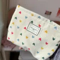 Off-white corduroy makeup pouch featuring colorful heart patterns and a front label. - Beige Heart / 26 x 18 cm