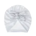 Detail shot of soft white baby turban hat with cute triple knot bow design for infants. - One Size / White