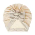 Close up of baby bow turban hat, soft knitted pleated infant headwear in beige color. - One Size / Beige