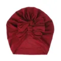 Red baby turban hat with cute knotted bow, soft knitted fabric infant headwear detail view. - One Size / Burgundy