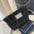 Black tweed cosmetic bag with zipper closure, portable makeup pouch for women and daily storage. - Black