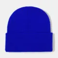 Close-up detail shot of a bright blue knitted winter beanie hat with a cuffed design. - Sapphire Blue