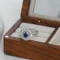 Close up detail of the luxury blue stone halo zirconia open ring in wooden box display. - Silver