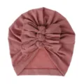 Detailed view of the cute baby turban hat with stylish triple bows and soft pleated knit fabric. - One Size / Dusty Pink