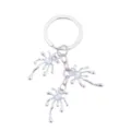Silver alloy liquid shape keychain with shiny opal gemstone beads, trendy bag charm detail. - Fluid Metal Style