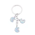 Detailed view of a fashionable alloy crystal star and moon keychain charm and bag pendant. - Moon and Star Style