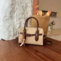 Vintage suede crossbody shoulder bag, classic retro handbag with top handle and chic charm. - With Pendant / Beige