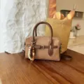 Brown retro suede handbag detail view, showing exquisite leather strap and wooden bead charm. - With Pendant / Khaki