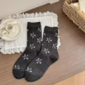 Dark grey mid-tube socks for women featuring cute white floral bow patterns, cozy cotton style. - Star