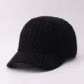 Closeup of a black knitted baseball cap, soft woolen material with classic texture detail. - Adjustable / Diamond Pattern - Black