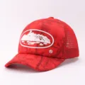 Red mesh truck cap with stylish cruise ship graphic front design for summer sun protection. - Adjustable / Camouflage Cruise - Red