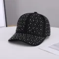 Close-up detail of a sparkling rhinestone-embellished black baseball cap surface. - Adjustable / Black and White