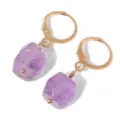 Close-up detail of purple amethyst raw stone drop earrings with gold-plated hoops. - Purple Crystal