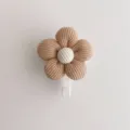 Detail shot of a minimalist brown fabric flower wall hook with a textured white center - 6*8cm / Coffee Flower (White Hook)
