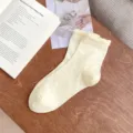 Women's cute ruffle trim crew socks with delicate bow pattern, soft cream color. - One Size / Off White