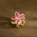 Macro detail of a pink frangipani flower hair claw clip with gold metal finish - 3.50cm / Pink