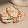 Elegant gold ocean charm bracelet with white pearls, pink shell, and purple starfish - Ocean Elements Pearl Fish Tail (9# Pearl)