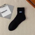 Black men's mid-tube cotton socks with stylish blue letter embroidery for daily street wear. - One Size / Black