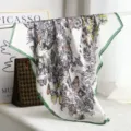 Silk square scarf featuring intricate floral and butterfly prints with green hem details. - H07