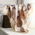 Detailed view of luxury baroque silk scarf featuring ornate chain and jewel print patterns. - H11