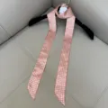Detailed view of the pink and white houndstooth slim silk twilly scarf with elegant aesthetic. - SD140 - Pink Houndstooth