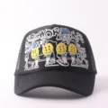 Close-up view of black trucker cap featuring detailed embroidery, smiley faces, and mesh. - Adjustable / Button Smiley Face - Black