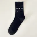 Black retro bow mid-calf cotton socks with heart knit pattern and sweet ruffled cuff design. - One Size / Black