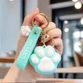 Detailed view of cute mint green cat paw keychain with Lucky Day embossed soft strap - Blue
