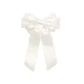 Detail view of the smooth white satin texture on the three-layered ribbon bow hair clip - White