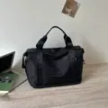 Black travel duffel bag detail, portable handbag and fitness gym bag for women short trips. - Black