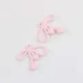 Detailed close-up shot of cute pink enamel bow alloy charms for DIY jewelry making. - 20 Pieces Set / Pink