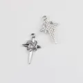 Detailed view of silver alloy dagger and cross charms with sparkling cubic zirconia stones. - Silver / White Zirconia