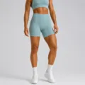 High-waisted athletic yoga shorts and sports bra set in light blue, perfect for fitness. - Green Shorts / S