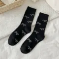 Black mid-calf socks featuring a cute white bow pattern, Korean style cotton cute socks. - One Size / Black