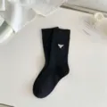 Black ribbed mid-calf socks for women featuring elegant white embroidery style. - One Size / Smiley Black