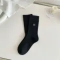 Black ribbed mid-tube socks featuring elegant white camellia embroidery, stylish autumn wear. - One Size / Flower Black