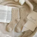 Women's cable knit wool blend mid-tube socks in classic khaki, cozy winter thermal wear. - One Size / Beige