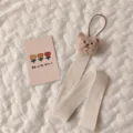 Detailed view of cute plush bear hair clip organizer strap with herringbone ribbon - 3D Bear Hair Accessory Organizer Strap / Milk Tea