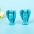 Detailed close-up of two carved blue stone angel figurines with natural black vein patterns - 1.5 Inch Taiwan Turquoise Angel