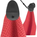 Detail view of red microfiber golf towel with black magnetic leather clip attachment - Red