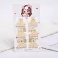 Detailed view showing six small cream pearl hair claws on a decorative display card. - Triangle Style (a14) / 6 Pieces/Pack (Small) / Pearl White