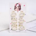 Detail view of six small pearl hair claw clips attached to a decorative cardboard display card - Round Style (a6) / 6 Pieces/Pack