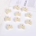 Elegant mini pearl hair claw clips in creamy white for versatile hair styling accessories - 镂空对称三角款 / 10 Pieces/Pack