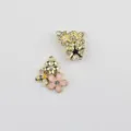 Close-up detail of cute alloy enamel bee and flower charms with rhinestone, perfect for DIY jewelry. - Gold Base Pink Flower