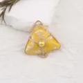 Close-up detail view of traditional yellow brocade zongzi pendant with metal frame. - Bright yellow